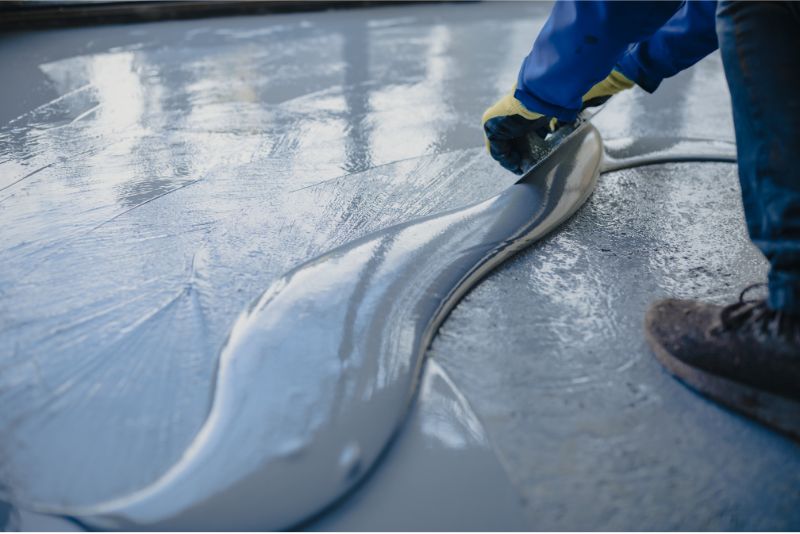 A photo of gre epoxy being spread on a driveway