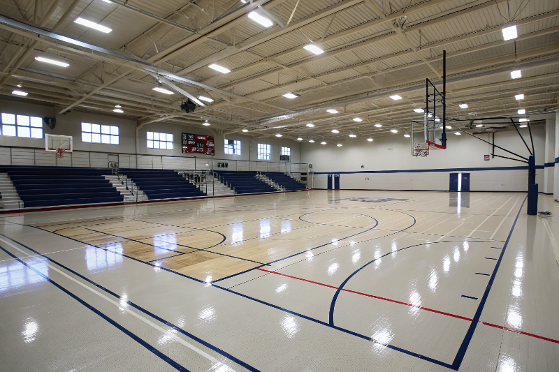 epoxy-sports-flooring-school-gymnasium Epoxy sports flooring in school gymnasium with basketball court markings and seamless surface