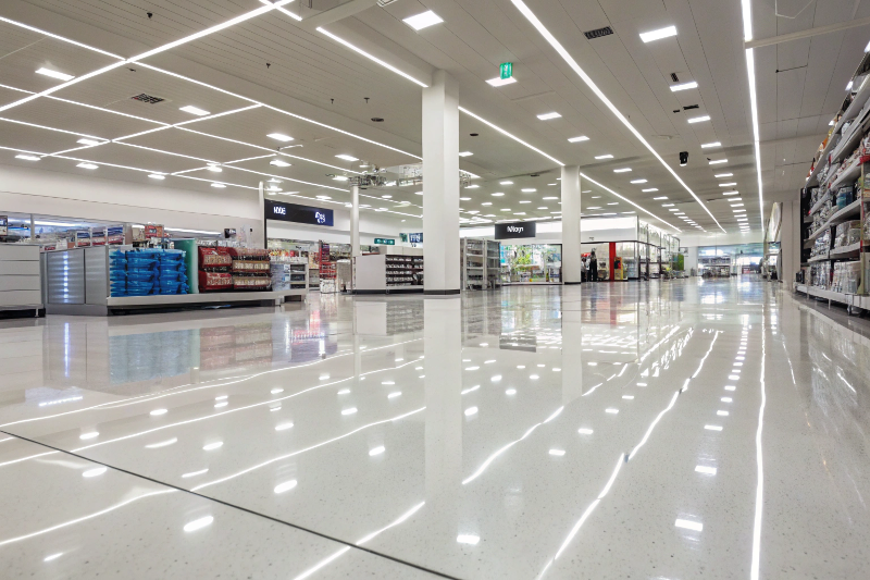 Professional epoxy retail flooring installation in Sutherland Shire store showing glossy reflective surface